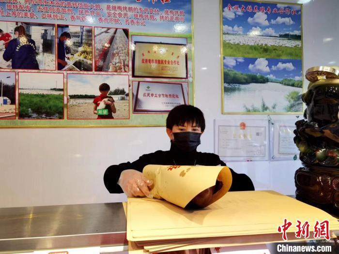 圖為鄭繼梅正在打包烤鵝。　謝宏秀供圖